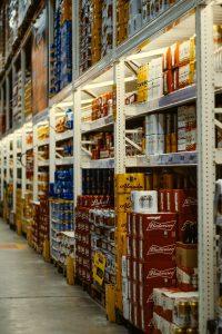 red and white labeled cans on shelf/ Tier-Rack