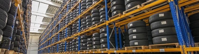 Stacks of tires organized on heavy-duty tire racks.